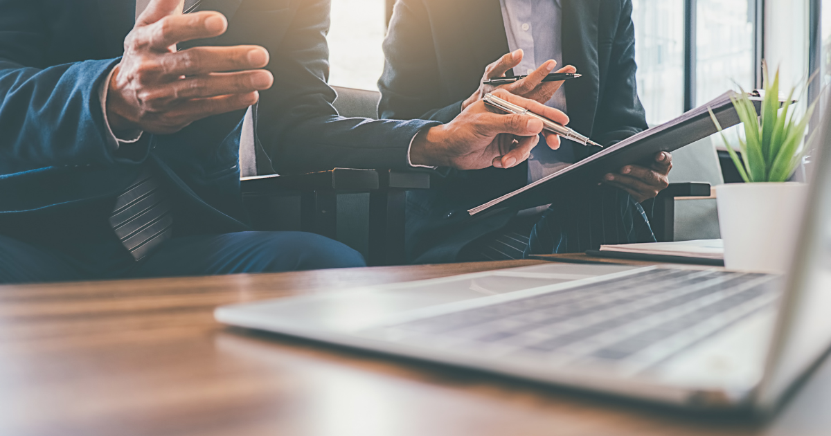 パソコンと書類を前に打ち合わせをする様子