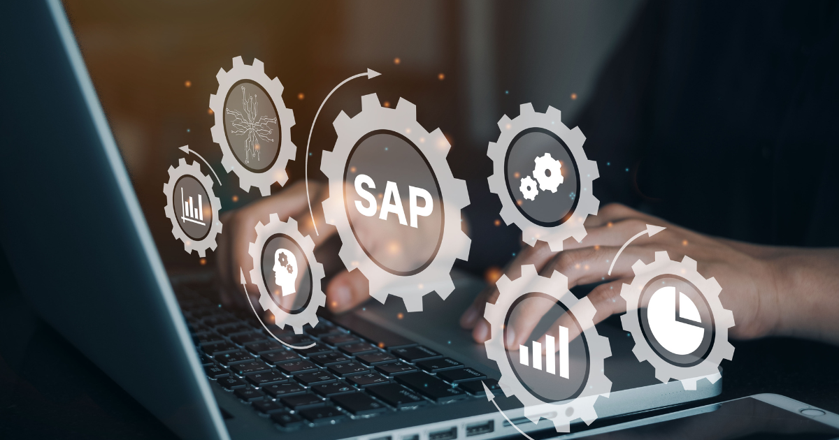 ノートパソコンを操作する手元と、「SAP」の文字が入った歯車のデジタルグラフィック